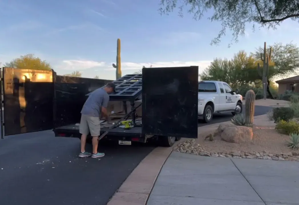 A crew member loading the trailer outside a desert home in Carefree