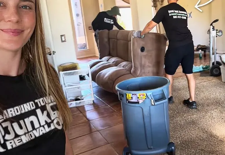 The crew carrying a sofa out during a whole-house cleanout in Cave Creek