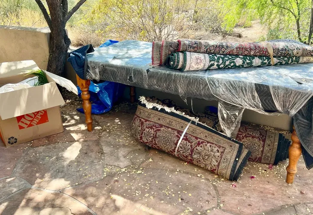 A mattress and rolled rugs set out for pickup at a DC Ranch home
