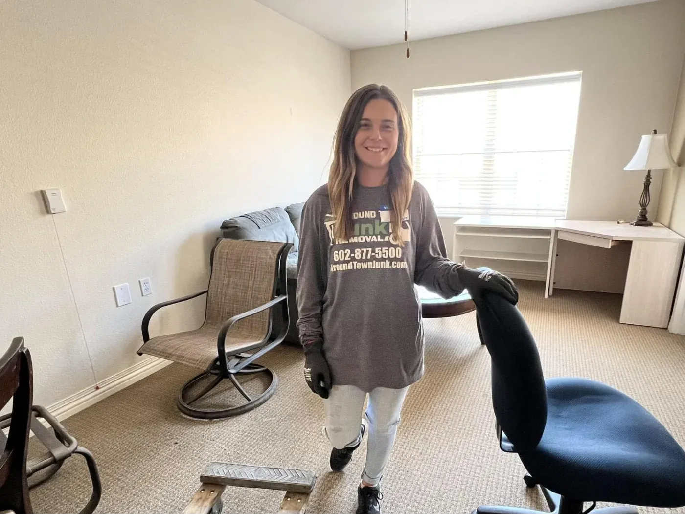 A crew member clearing chairs and furniture from a Sun City West apartment
