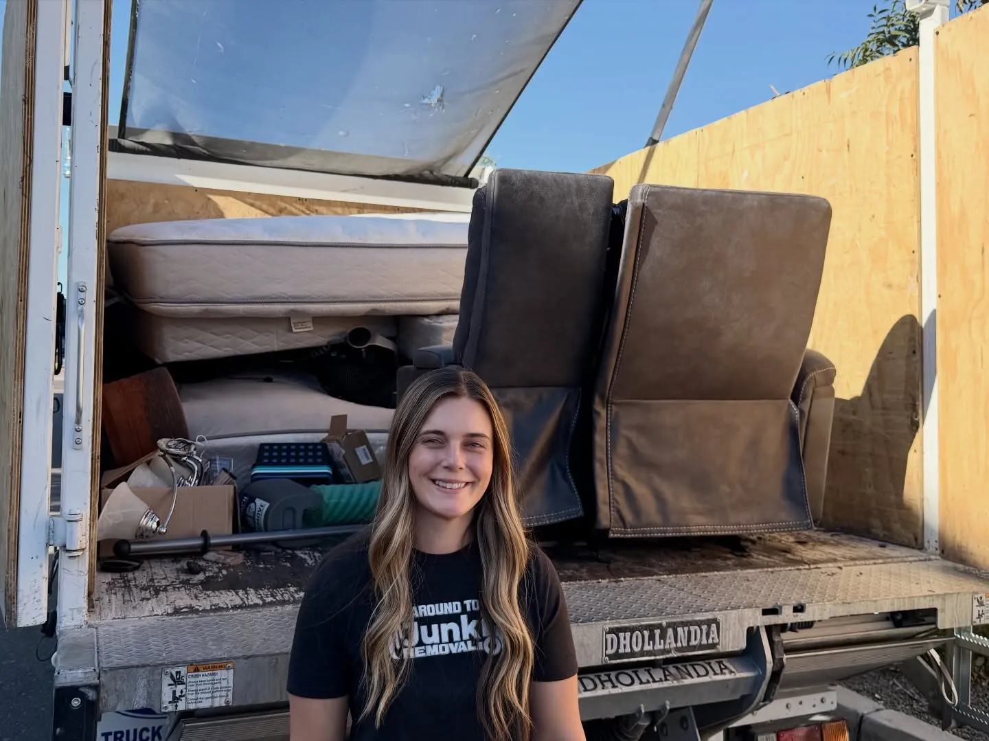 A crew member in front of a carefully loaded truck