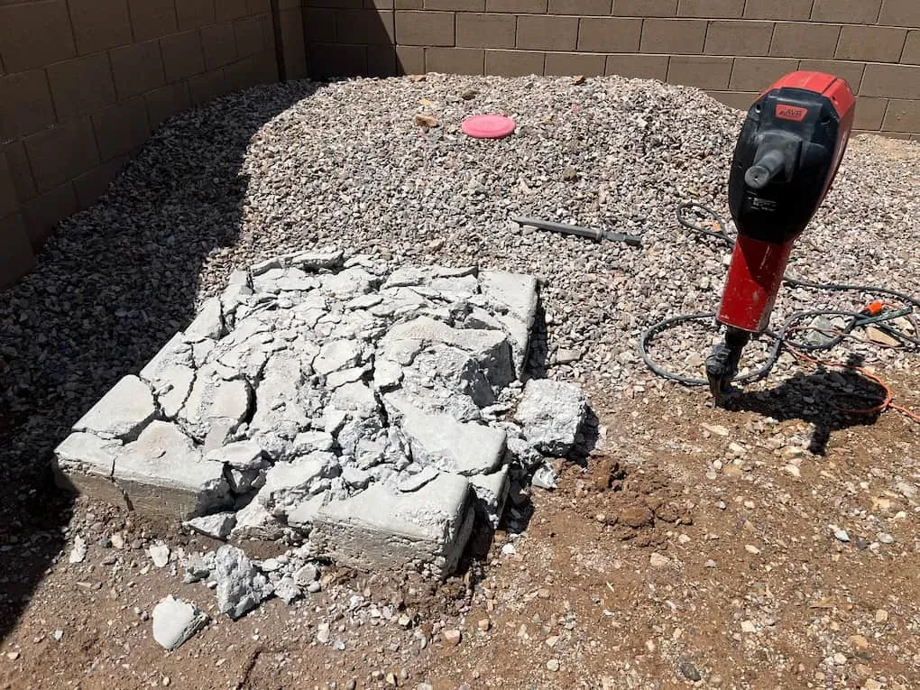 A concrete slab broken up with a jackhammer in a Phoenix backyard