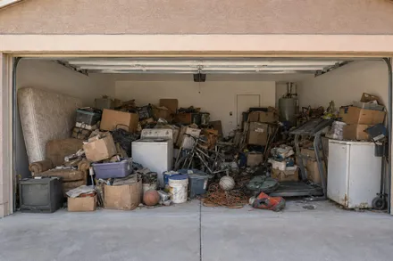 Customer photo of a garage full of junk