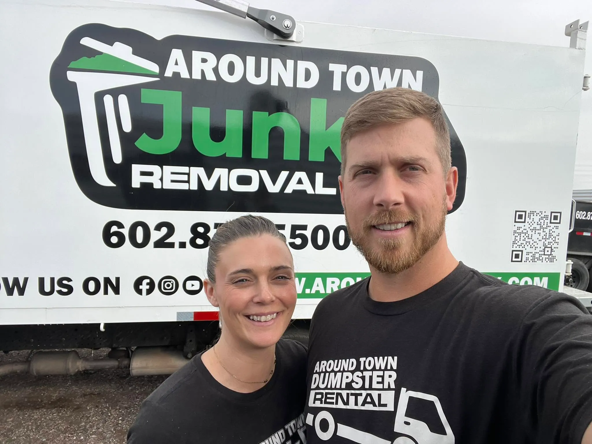 Garrett and Megan Frix in front of the Around Town Junk Removal truck