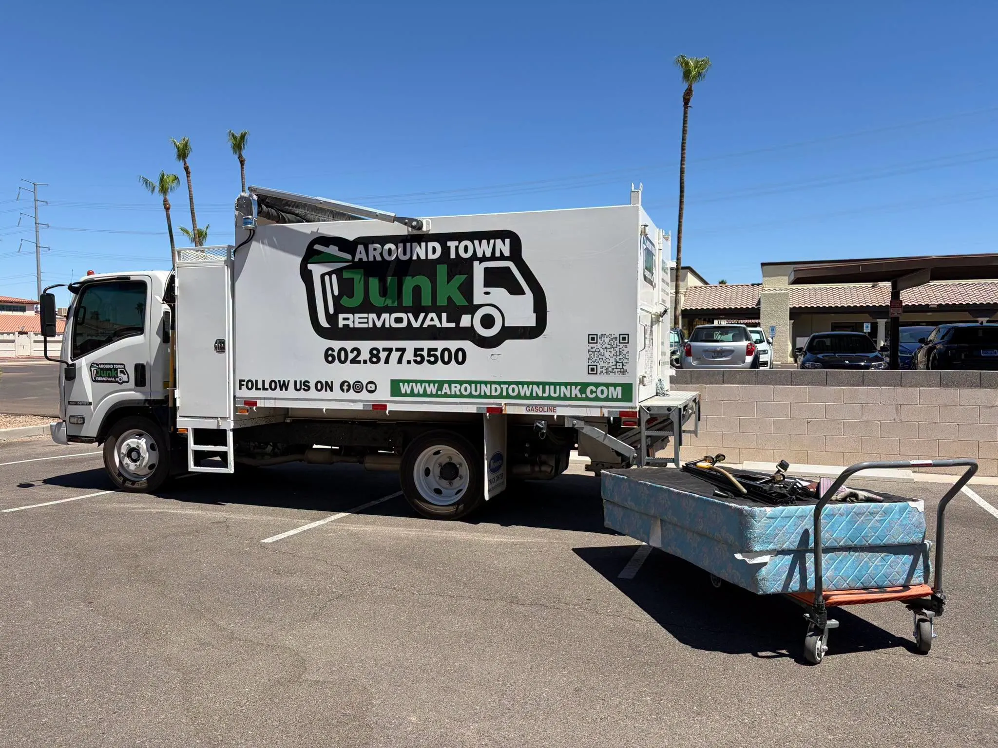 The truck parked with a mattress on a dolly during a storage cleanout